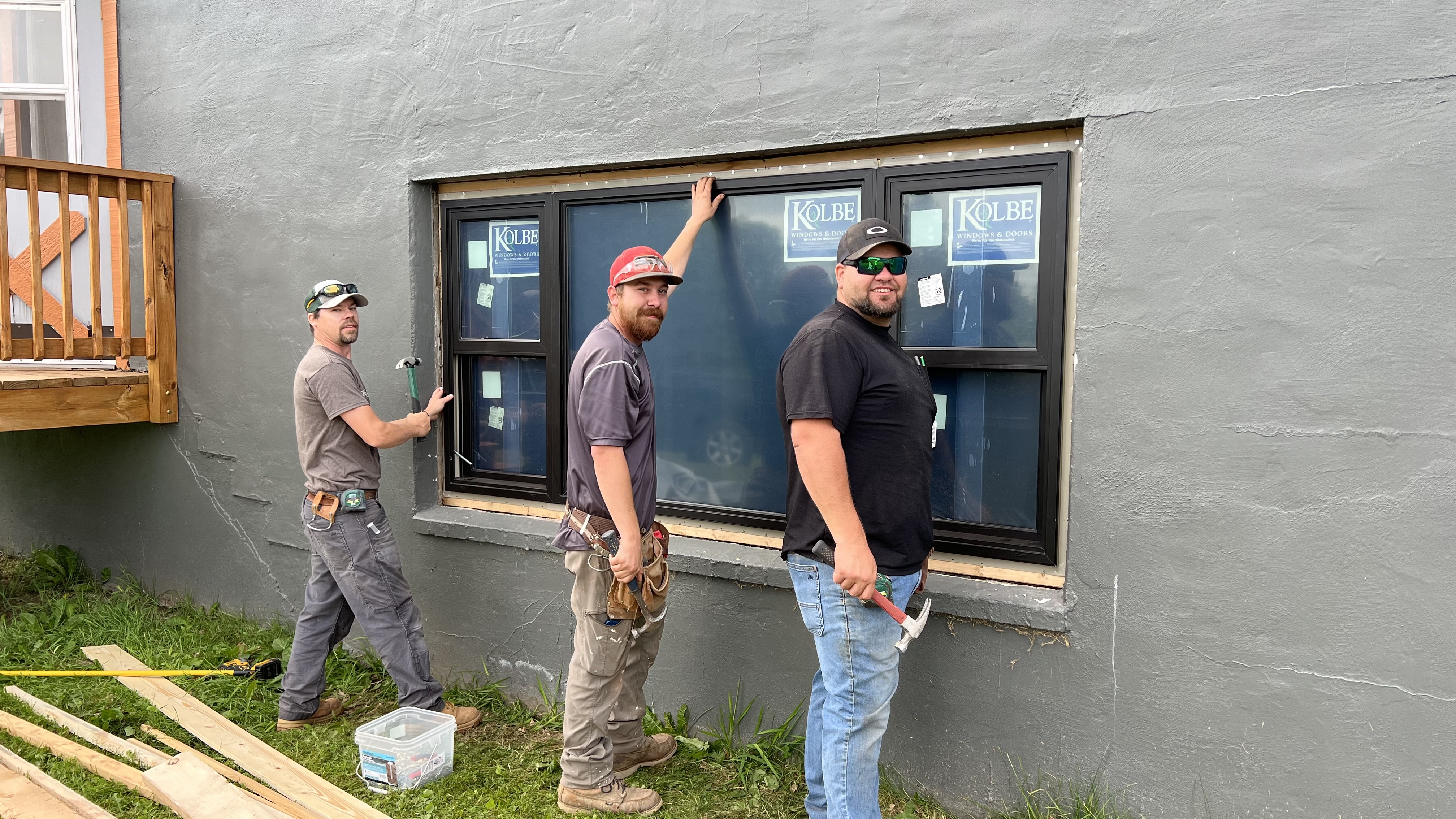 Jonah, Austin and Cameron installing a window in the Gabbro Suites