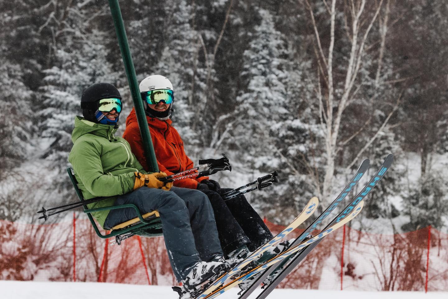 two skiers riding a lift