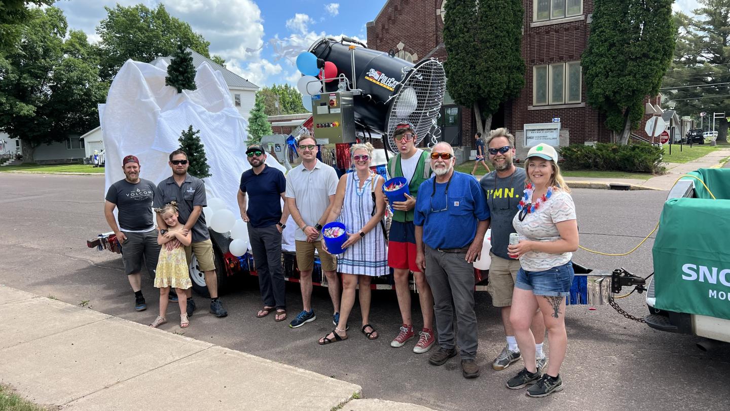 snowriver staff in front of a parade float