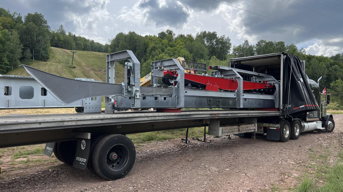 Ski lift parts on the bed of a semi truck waiting to be unloaded.