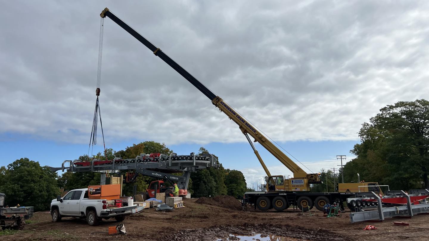 Crane hoisting a runway into place.