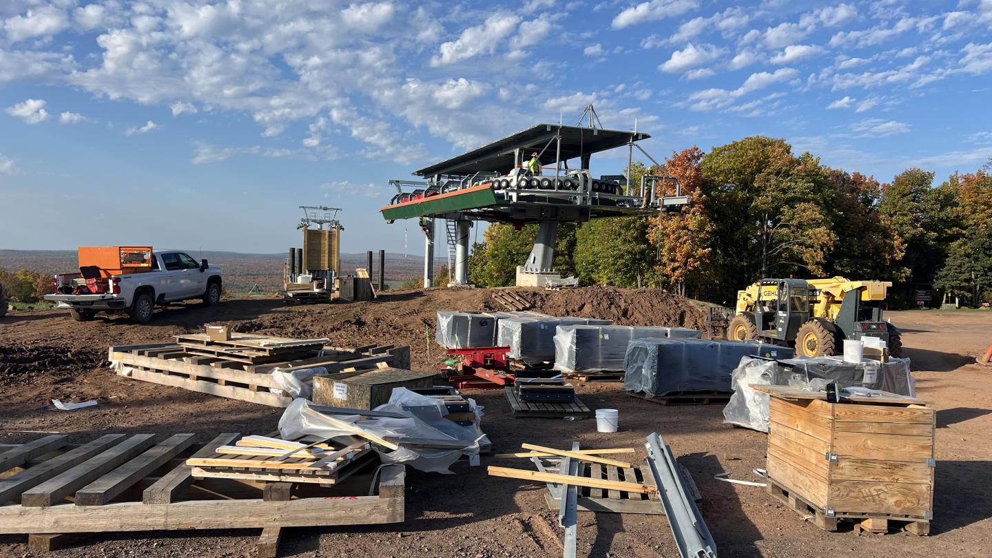 Components sit on pallets awaiting installation into the new lift.