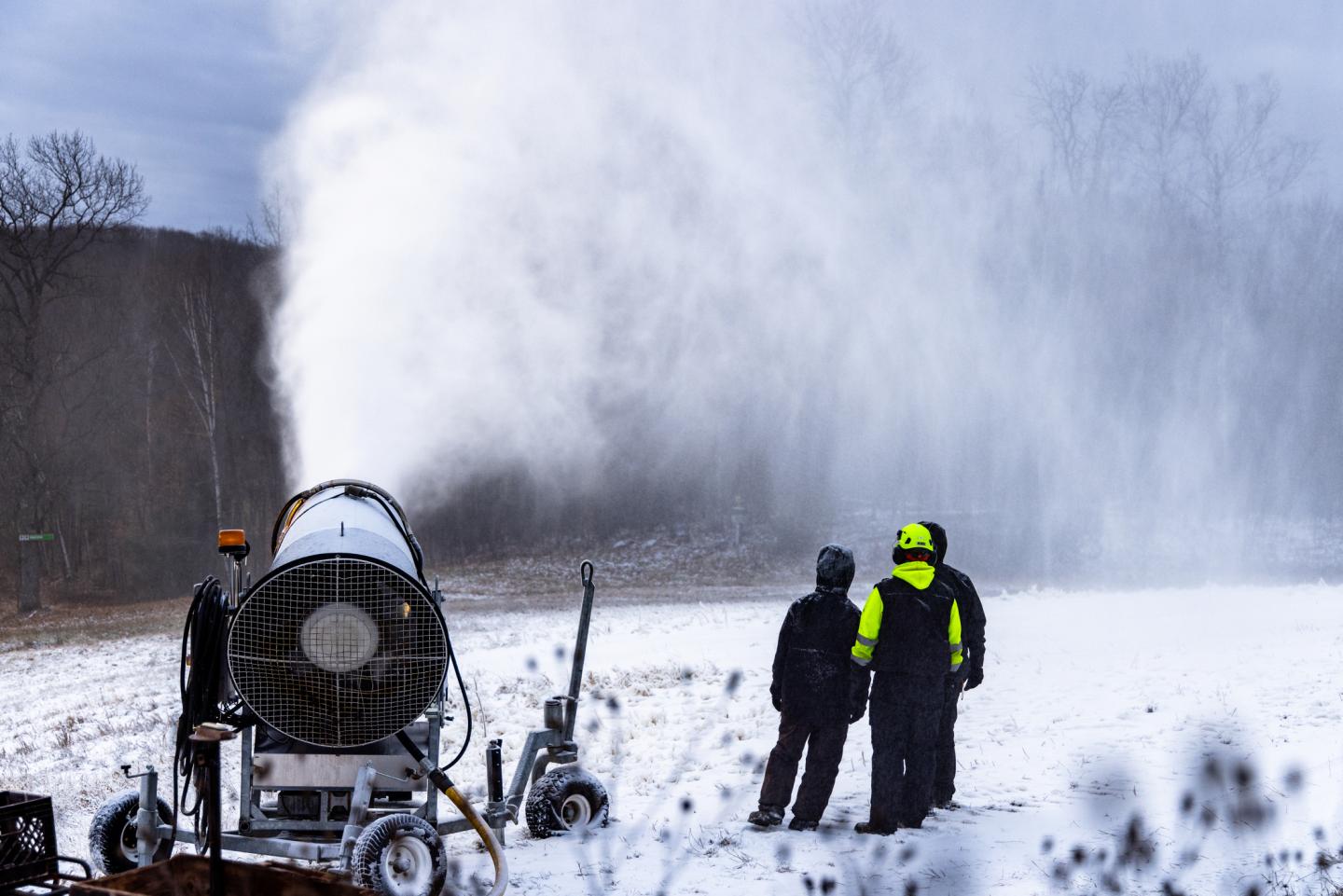 Snowmakers watch a plume to see if they've aimed the gun correctly.