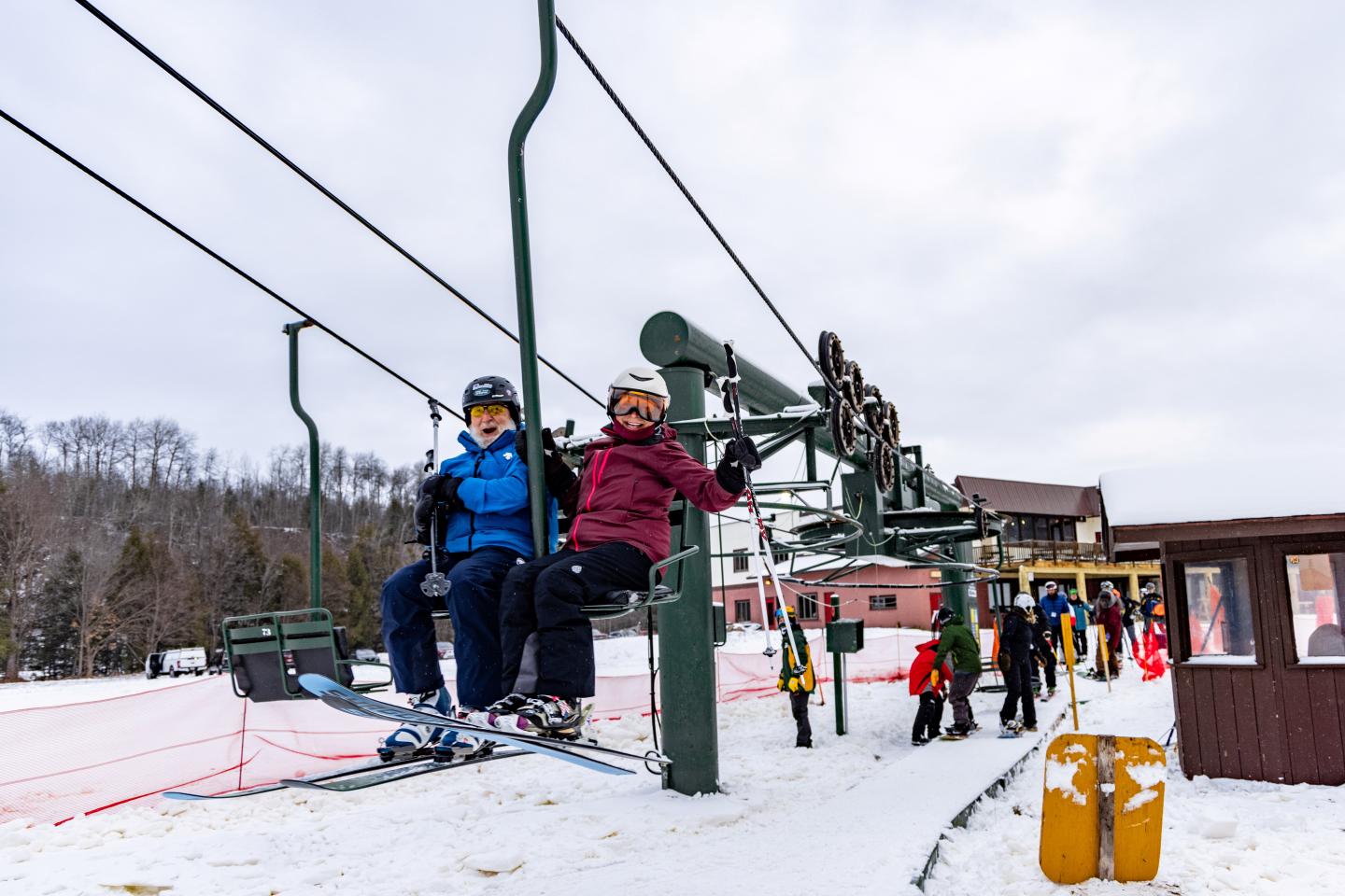 First skiers riding up the lift on opening day.