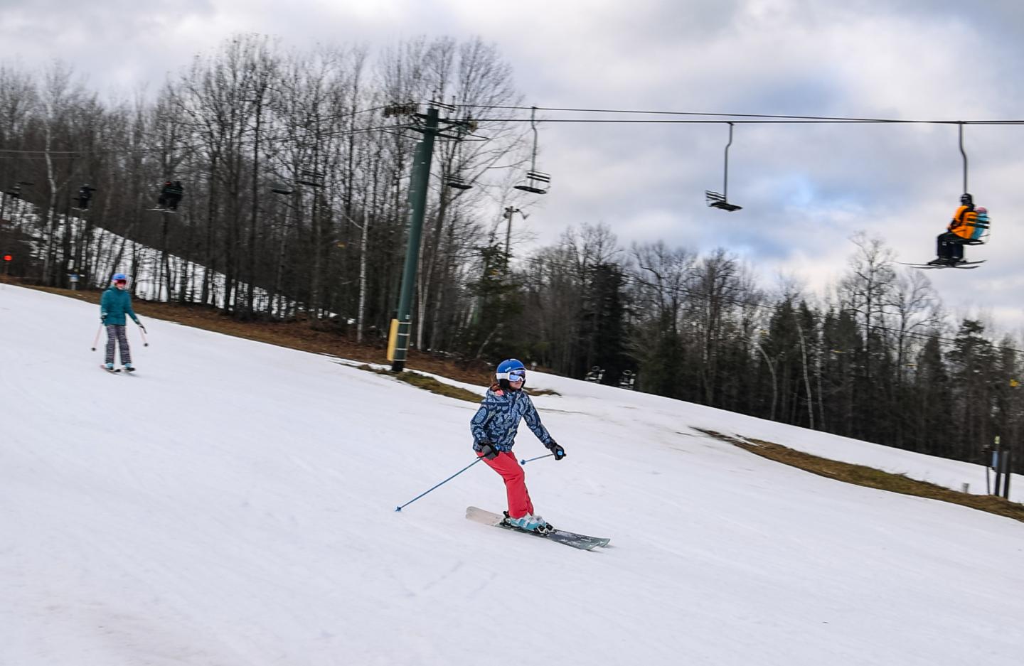 Skiers skiing in spring like conditions at Black River Basin.