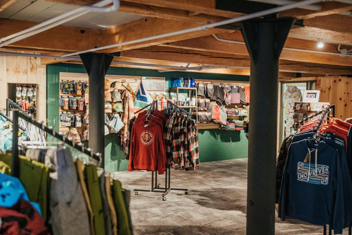 Clothing store interior with racks of shirts and accessories.