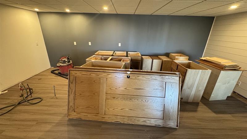 Stacked wooden cabinets in a room under renovation.