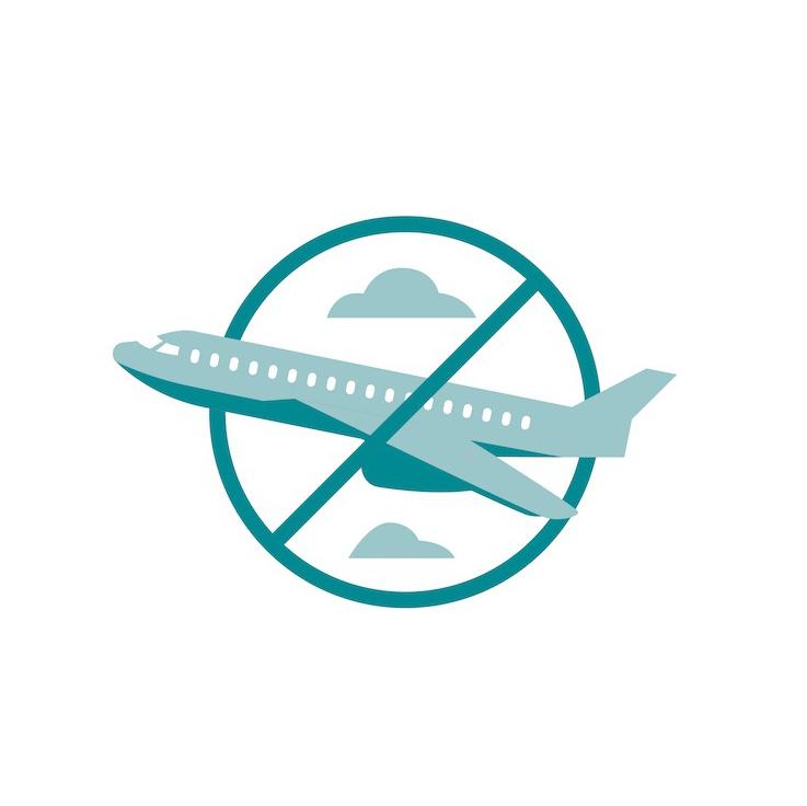 Airplane with slash through it in a circle, clouds in background.