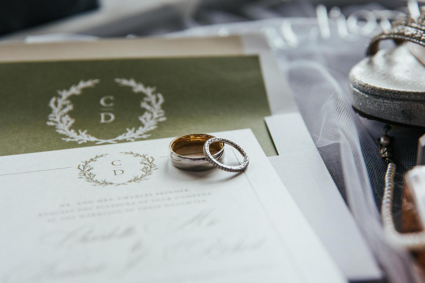 Wedding invitation set with intertwined rings on top.